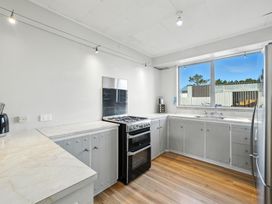 A kitchen with stove, sink, and cabinets at Birdlings Flat in Banks Peninsula