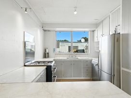 A kitchen with a gas stove and refrigerator at Birdlings Flat, Banks Peninsula