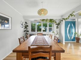 A dining room with a long table and chairs at Birdlings Flat in Banks Peninsula