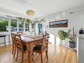 A dining room with a wooden table and chairs at Birdlings Flat in Banks Peninsula