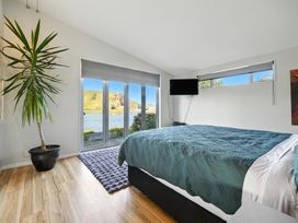A bedroom with a bed and television at Birdlings Flat, Banks Peninsula