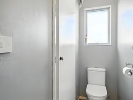 A bathroom with a toilet and window at Birdlings Flat in Banks Peninsula