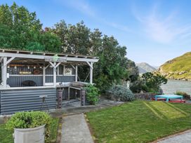 An outdoor area with a barbecue and seating at Birdlings Flat Banks Peninsula