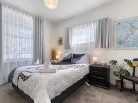 A bedroom with a bed and bedside table at Ohakune Holiday Home in Ohakune