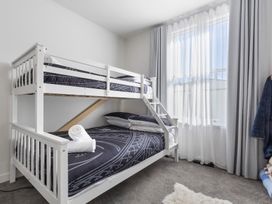 A bedroom with a bunk bed and window at Ohakune Holiday Home in Ohakune