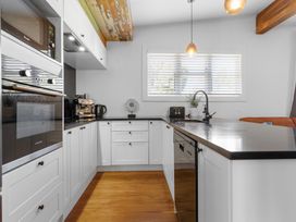 A kitchen with a counter, sink, and appliances at Ohakune Holiday Home in Ohakune