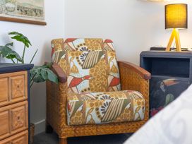 A living room with an armchair and side table at Ohakune Holiday Home Ohakune