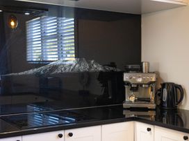 A kitchen with a coffee machine and kettle at Ohakune Holiday Home, Ohakune