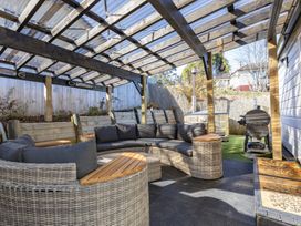 An outdoor patio with seating and a barbecue grill at Ohakune Holiday Home in Ohakune