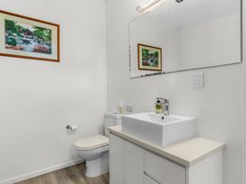 A bathroom with a sink and toilet at Mangawhai Heads Holiday Home in Mangawhai Heads
