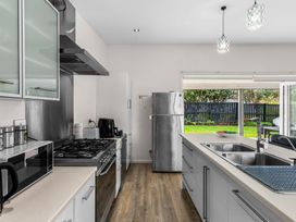 A kitchen with appliances and countertops at Mangawhai Heads Holiday Home in Mangawhai Heads