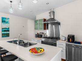 A kitchen with appliances and a colorful bowl at Mangawhai Heads Holiday Home Mangawhai Heads