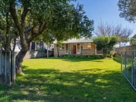 A house with a garden area and trees at They Carolyn - Whangamata Holiday Home in Whangamata