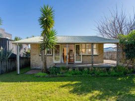 A house with a garden and trees at They Carolyn - Whangamata Holiday Home Whangamata