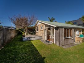 A house with a deck in the backyard at They Carolyn - Whangamata Holiday Home Whangamata