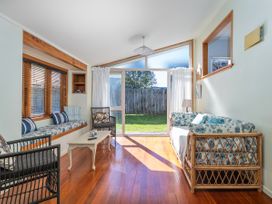 A living room with a sofa and coffee table at They Carolyn - Whangamata Holiday Home, Whangamata