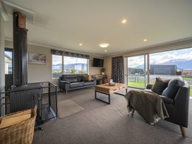 A living room with furniture and views at Te Anau