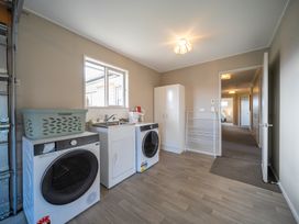 A laundry room with washing machine and dryer at Te Anau