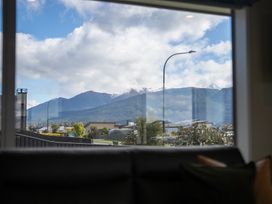 A view of mountains and houses from inside at Te Anau