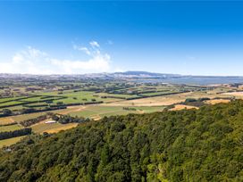 A panoramic view of farmland and forested areas at Hill Cottage - Featherston Holiday Home Featherston