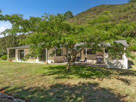 A house with a patio and grill at Hill Cottage - Featherston Holiday Home Featherston