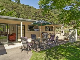 An outdoor patio area with a table and chairs at Hill Cottage - Featherston Holiday Home in Featherston