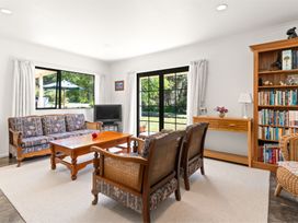 A living room with a sofa and coffee table at Hill Cottage - Featherston Holiday Home, Featherston