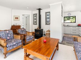 A living room with a sofa and coffee table at Hill Cottage - Featherston Holiday Home in Featherston