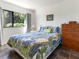 A bedroom with a bed and chest of drawers at Hill Cottage - Featherston Holiday Home in Featherston