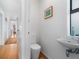 A bathroom with toilet and sink at Waihi Beach Holiday Home in Waihi Beach