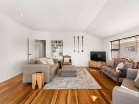 A living room with a sofa and television at Waihi Beach Holiday Home in Waihi Beach