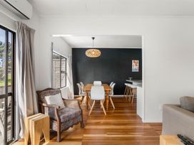 A dining room with a table and chairs at Waihi Beach Holiday Home in Waihi Beach