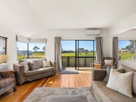 A living room with sofas and a view at Waihi Beach Holiday Home in Waihi Beach