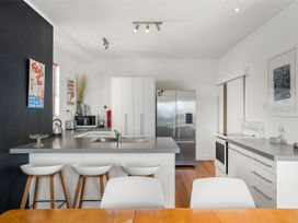 A kitchen with a refrigerator and oven at Waihi Beach Holiday Home in Waihi Beach
