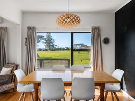 A dining room with a table and chairs at Waihi Beach Holiday Home Waihi Beach