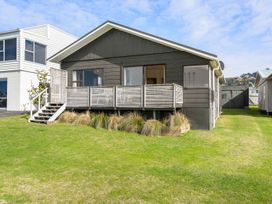 A house with a deck and steps in front at Waihi Beach Holiday Home Waihi Beach