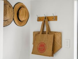 An entryway with hats and bags hanging on a coat rack at Waihi Beach Holiday Home Waihi Beach