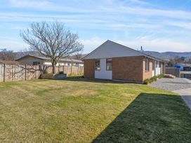 An outdoor view of a house and grassy area at Antimony Retreat - Cromwell