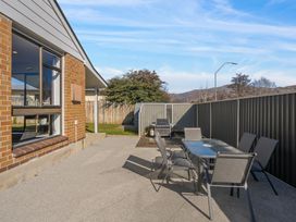 An outdoor area with a table and chairs at Antimony Retreat - Cromwell Holiday Home, Cromwell