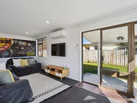 A living room with a sofa and television at Antimony Retreat - Cromwell