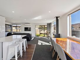A living room with a dining area and kitchen island at Antimony Retreat - Cromwell