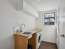 A laundry room with a sink and washing machine at Antimony Retreat - Cromwell