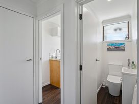 A bathroom with a toilet and sink at Antimony Retreat - Cromwell Holiday Home in Cromwell