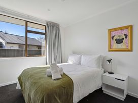 A bedroom with a bed and window at Antimony Retreat - Cromwell Holiday Home in Cromwell
