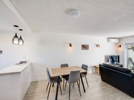 A dining room with a table and chairs at Sea-renity - Napier Holiday Home Napier South