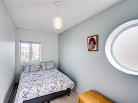 A bedroom with a bed and window at Sea-renity - Napier Holiday Home, Napier South