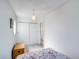 A bedroom with a bed and a chest at Sea-renity - Napier Holiday Home in Napier South