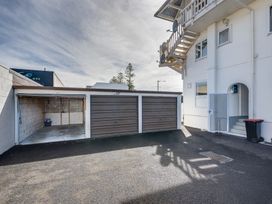 An outdoor area with a garage and driveway at Sea-renity - Napier Holiday Home, Napier South
