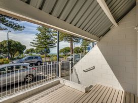An outdoor area with trees and parked vehicles at Sea-renity - Napier Holiday Home Napier South