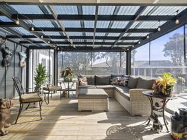 A conservatory with seating and plants at the property